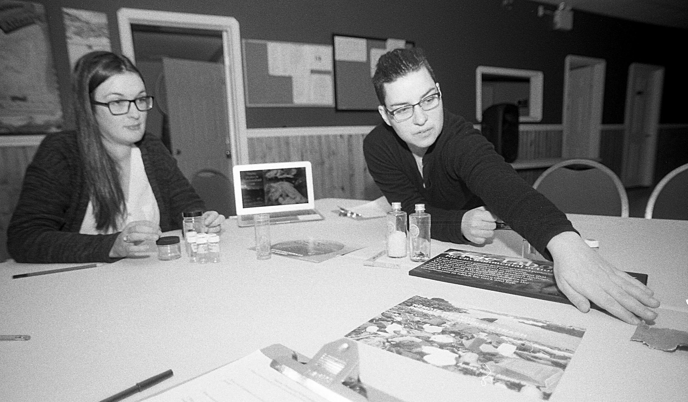 Photo of two women with plastic samples on the table in front of them